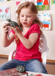 little girl with dinosaur best air dry clay for kids verycreate.com